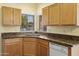 Open kitchen featuring wood cabinets, granite countertops, and modern appliances at 3407 W Steinbeck Dr, Anthem, AZ 85086