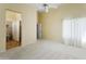 Large main bedroom features a ceiling fan, neutral carpet, and adjoining bathroom at 3407 W Steinbeck Dr, Anthem, AZ 85086
