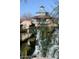 Close-up of a quaint building atop a rock structure and small waterfall at 3407 W Steinbeck Dr, Anthem, AZ 85086