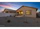 Spacious backyard featuring a covered patio, desert landscaping, and block wall at 40005 W Rio Lobo Dr, Maricopa, AZ 85138