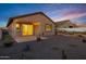 Backyard features a covered patio and a low-maintenance desert landscape with cacti and desert mural at 40005 W Rio Lobo Dr, Maricopa, AZ 85138