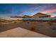 Desert landscaping and mural on block wall enhance the appeal of this private backyard at 40005 W Rio Lobo Dr, Maricopa, AZ 85138