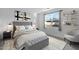 Cozy bedroom featuring a tufted headboard, neutral color scheme, and a window with scenic views at 40005 W Rio Lobo Dr, Maricopa, AZ 85138