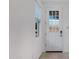 Bright entryway features a white door with glass, a window, and views of the main living space at 40005 W Rio Lobo Dr, Maricopa, AZ 85138