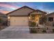 Charming single-Gathering home featuring a two-car garage, desert landscaping, and covered porch at 40005 W Rio Lobo Dr, Maricopa, AZ 85138