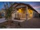 Inviting front exterior featuring stone accents, desert landscaping, and an covered porch at 40005 W Rio Lobo Dr, Maricopa, AZ 85138