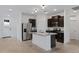 Modern kitchen features stainless steel appliances, dark wood cabinets, and an island with granite countertops at 40005 W Rio Lobo Dr, Maricopa, AZ 85138
