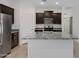 Close up of the kitchen with stainless steel appliances, granite countertops, and modern cabinetry at 40005 W Rio Lobo Dr, Maricopa, AZ 85138