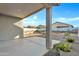 Covered patio featuring a concrete slab floor and exterior lighting at 40005 W Rio Lobo Dr, Maricopa, AZ 85138