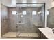 Modern bathroom showcasing a spacious shower with gray tiles and glass enclosure, plus double vanity and modern fixtures at 40101 N Alameda Dr, San Tan Valley, AZ 85140