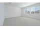 Bright, open bedroom with carpet and natural light streaming in through large windows at 40101 N Alameda Dr, San Tan Valley, AZ 85140