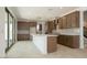 Modern kitchen features a large island, ample storage, stainless appliances, and sliding doors to the backyard at 40101 N Alameda Dr, San Tan Valley, AZ 85140