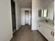 Modern bathroom with double vanity, white cabinets, and a glass-enclosed shower at 4329 E Brook Lynn Pl, San Tan Valley, AZ 85143