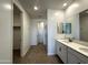 Bathroom with double sinks, modern vanity, wood-look floors, and glass-enclosed shower at 4329 E Brook Lynn Pl, San Tan Valley, AZ 85143