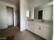Bathroom featuring double sinks, a large mirror, and glass enclosed shower at 4329 E Brook Lynn Pl, San Tan Valley, AZ 85143
