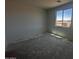 A well-lit bedroom features a single window offering views of the outside, awaiting personalization at 4329 E Brook Lynn Pl, San Tan Valley, AZ 85143