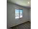 Simple bedroom with a large window offering exterior views, and neutral carpet flooring at 4329 E Brook Lynn Pl, San Tan Valley, AZ 85143