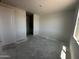 A bedroom with natural light filtering through a window and featuring an ensuite bathroom, ready for its new owner at 4329 E Brook Lynn Pl, San Tan Valley, AZ 85143