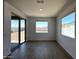 Spacious bonus room with wood-style floors, natural light, and backyard access at 4329 E Brook Lynn Pl, San Tan Valley, AZ 85143