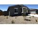 Stylish gray home featuring rock accents and desert landscaping for low maintenance in the front yard at 4329 E Brook Lynn Pl, San Tan Valley, AZ 85143