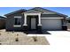 Charming single-story home featuring a gray exterior, well-kept landscaping, and an attached two-car garage at 4329 E Brook Lynn Pl, San Tan Valley, AZ 85143