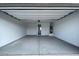 Spacious and clean garage interior with a high ceiling, offering ample room for parking and storage at 4329 E Brook Lynn Pl, San Tan Valley, AZ 85143