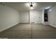 Spacious garage interior featuring a white door and modern water heater system at 4329 E Brook Lynn Pl, San Tan Valley, AZ 85143