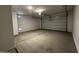 A clean, empty garage with a roll-up door, ready for parking and storage at 4329 E Brook Lynn Pl, San Tan Valley, AZ 85143