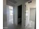 Hallway view showcasing bedroom and bathroom doors, with natural light from an adjacent room at 4329 E Brook Lynn Pl, San Tan Valley, AZ 85143