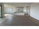 Open-concept kitchen with an island, white cabinets, and plenty of counter space at 4329 E Brook Lynn Pl, San Tan Valley, AZ 85143
