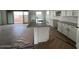 Bright, open kitchen featuring a large island, stainless steel sink, and modern white cabinetry at 4329 E Brook Lynn Pl, San Tan Valley, AZ 85143