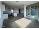 Spacious living room with tile floors and large glass sliding doors for abundant natural light at 4329 E Brook Lynn Pl, San Tan Valley, AZ 85143