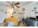 A serene bedroom boasts a ceiling fan, a work area, and charming decor at 4343 E Contessa St, Mesa, AZ 85205