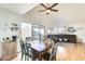 An inviting dining area and living room boasts ample natural light and a ceiling fan at 4343 E Contessa St, Mesa, AZ 85205