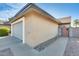A charming single-story home with a gray garage door, a private gated courtyard, and an easy-care desert rock landscape at 4343 E Contessa St, Mesa, AZ 85205