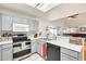 A partially remodeled kitchen features stainless steel appliances and a breakfast bar at 4343 E Contessa St, Mesa, AZ 85205