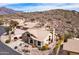Desert home boasts mature landscaping and a tile roof, nestled at the base of scenic mountain terrain at 4903 S Desert Willow Dr, Gold Canyon, AZ 85118