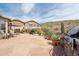 Desert backyard featuring an outdoor fireplace, grill, and scenic desert views at 4903 S Desert Willow Dr, Gold Canyon, AZ 85118