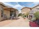 Inviting backyard space with outdoor fireplace, seating area, and desert landscaping at 4903 S Desert Willow Dr, Gold Canyon, AZ 85118
