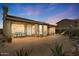 Backyard patio with covered lounge area, desert plants, and stone details at 4903 S Desert Willow Dr, Gold Canyon, AZ 85118