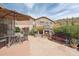 Desert backyard with outdoor fireplace, dining area, and mountain views at 4903 S Desert Willow Dr, Gold Canyon, AZ 85118