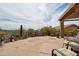Desert backyard BBQ area with lush landscaping and natural desert views at 4903 S Desert Willow Dr, Gold Canyon, AZ 85118