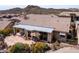 Desert home with a covered patio area and beautiful desert landscaping in the backyard, showcasing a tranquil outdoor space at 4903 S Desert Willow Dr, Gold Canyon, AZ 85118