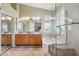 Bathroom with a double vanity, large mirror, soaking tub, and separate glass-enclosed shower at 4903 S Desert Willow Dr, Gold Canyon, AZ 85118