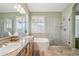 Bright bathroom features double vanity, tub, and glass-enclosed shower at 4903 S Desert Willow Dr, Gold Canyon, AZ 85118