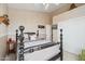 Bedroom featuring a decorative bed frame, neutral color palette, and double door closet at 4903 S Desert Willow Dr, Gold Canyon, AZ 85118