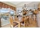 Open-concept dining area adjacent to a kitchen and living room with ample natural light at 4903 S Desert Willow Dr, Gold Canyon, AZ 85118