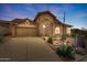 Charming two-story home features a desert landscaped front yard and attached two-car garage at 4903 S Desert Willow Dr, Gold Canyon, AZ 85118