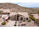 Charming single-story home with a tile roof and desert landscaping nestled against a scenic mountain backdrop at 4903 S Desert Willow Dr, Gold Canyon, AZ 85118