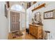 Bright foyer features hardwood floors, high ceilings, and decorative accents with a large front door at 4903 S Desert Willow Dr, Gold Canyon, AZ 85118